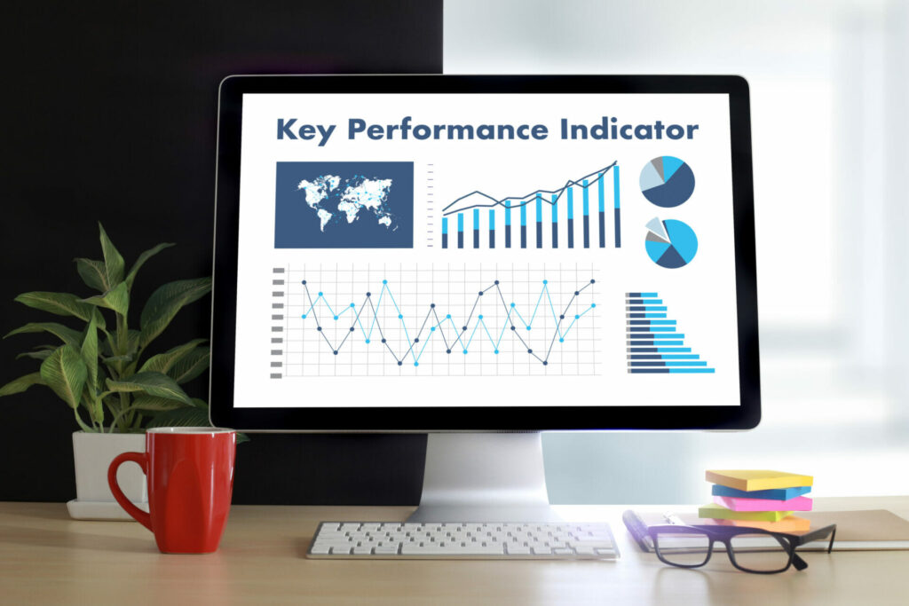 Computer monitor displaying Key Performance Indicators (KPIs) with graphs, charts, and a world map, highlighting data analysis for DTC marketing strategies.