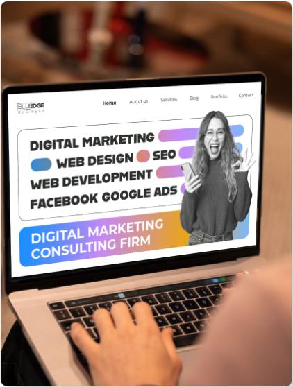 Person using laptop displaying Blue Edge Business website, featuring digital marketing, web design, SEO, and web development services.